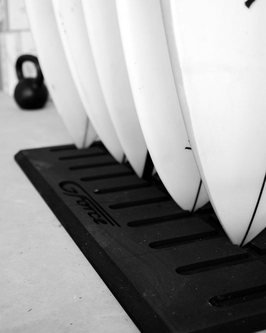 Closeup of five surfboard tails standing on the G-Force Board Mat