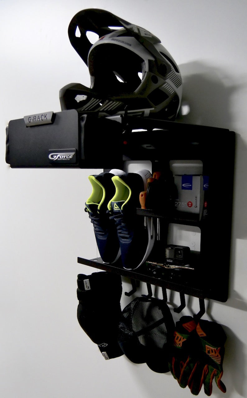 The G-Rack Model 1 - Wall Mounted Bike Rack holding a helmet, shoes, gloves, hat and other bike riding accessories
