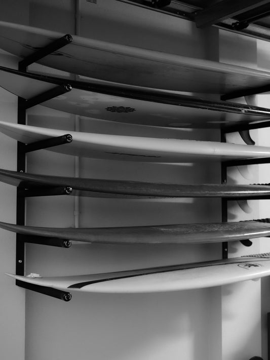 Six surfboards horizontally stacked on the G-Force GF14/6H wall mounted surfboard rack