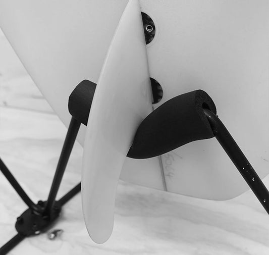 Closeup of a surfboard fin sitting in the G-Force Freestanding Surfboard Rack