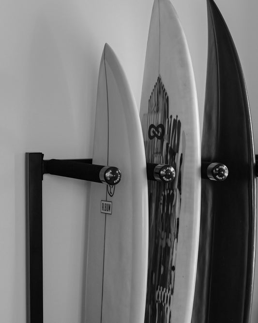 Three surfboards standing up in the G-Force GFP5 freestanding surfboard rack