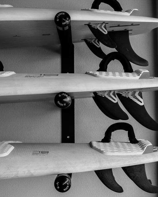 Three stand up paddle boards horizontally stacks on the wall mounted G-Force GFSUP3 SUP rack