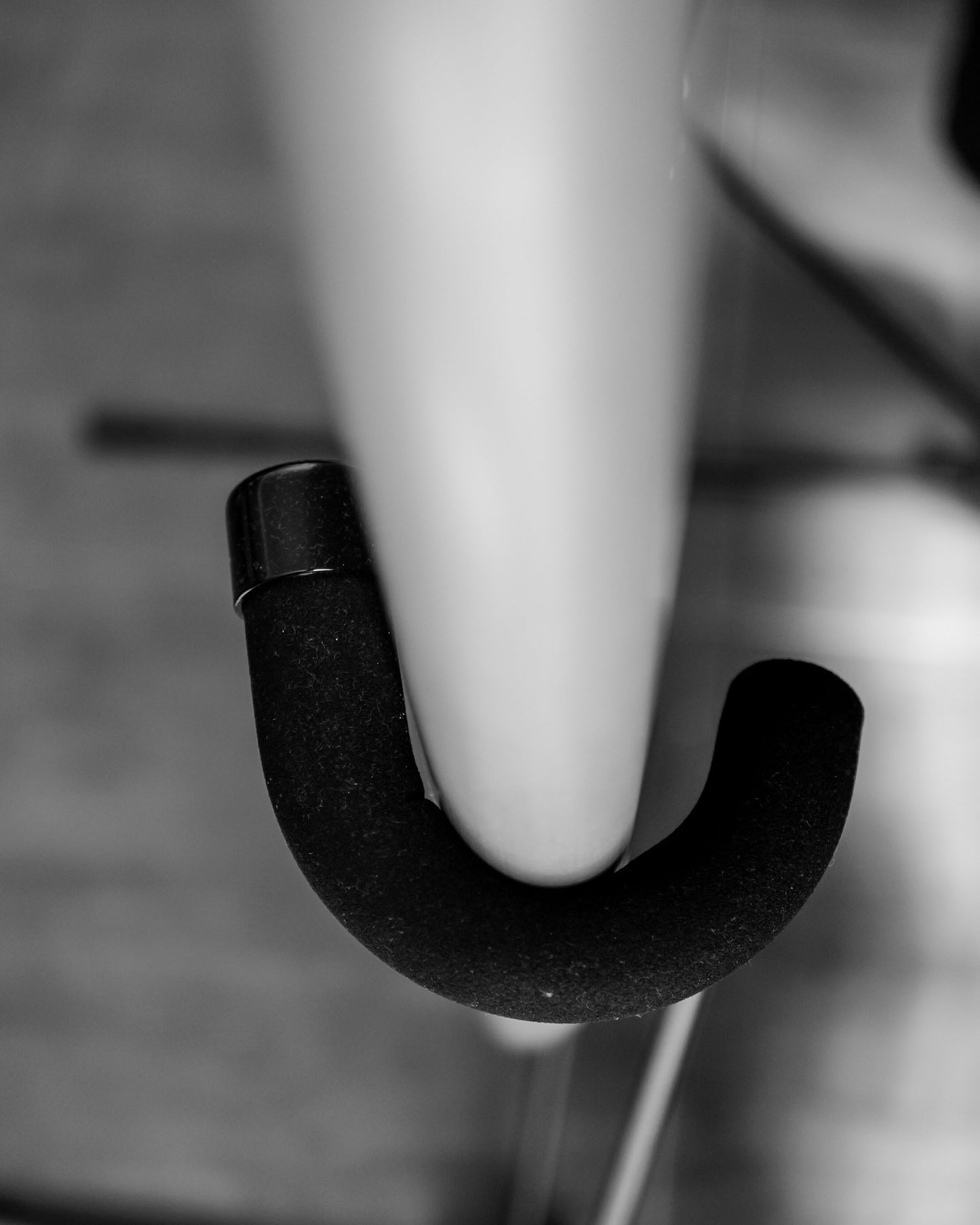 A closeup of a curved bar of a G-Force frestanding surfboard rack