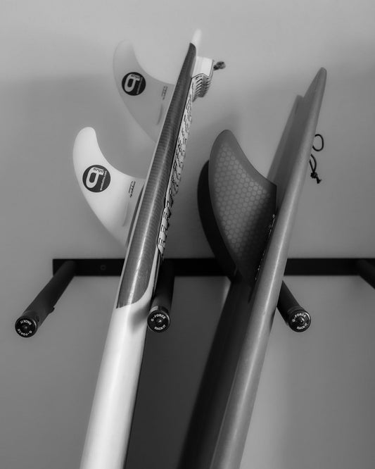 Two surfboards standing up in the G-Force GF14/4V wall mounted surfboard rack