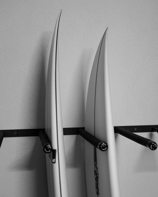 Two surfboards standing up in the G-Force GF14/8V wall mounted surfboard rack
