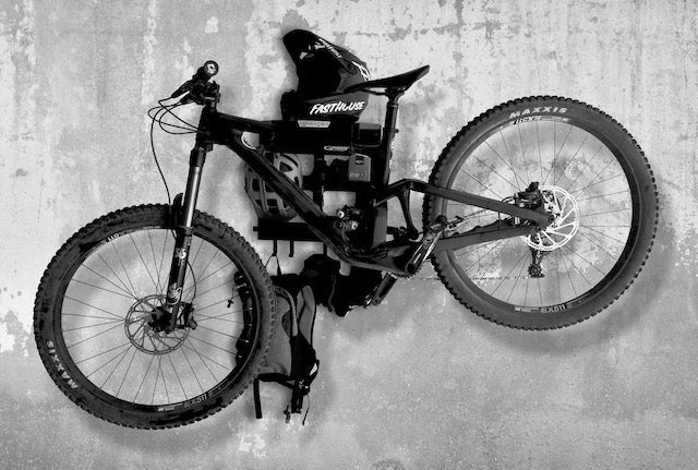 G-Force wall mounted G-Rack Model 1 Bike Rack holding a bike, multiple helmets & bike riding accessories