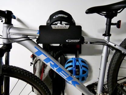 Close-up of the G-Rack Model 3 - Wall Mounted Bike Rack holding a bicycle, helmet, hat and other bike accessories